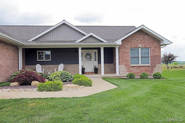 108 Buford Mountain Rd, Farmington, MO 63640 - view of front of home featuring a front yard, roof with shingles, board and batten siding, a porch, and brick siding