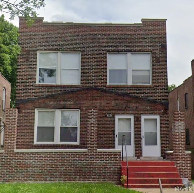 front facade featuring brick siding