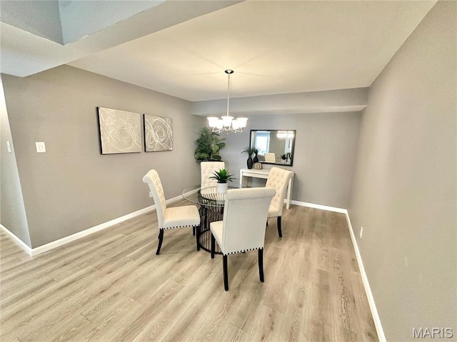 dining room with wood finished floors, baseboards, and a chandelier