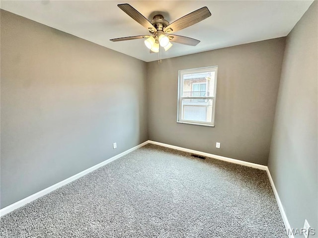 carpeted empty room with baseboards and ceiling fan