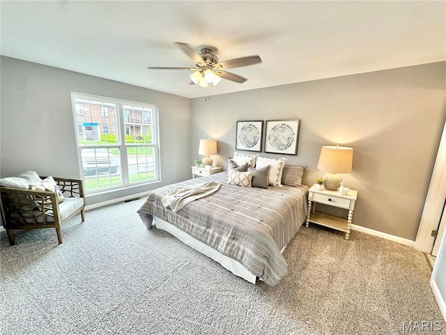 carpeted bedroom featuring ceiling fan and baseboards