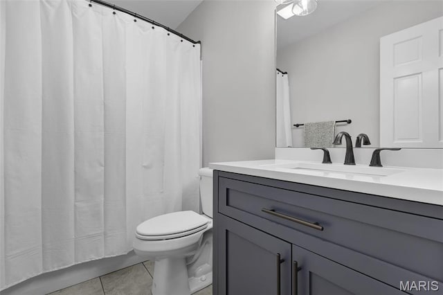 bathroom featuring toilet, tile patterned flooring, vanity, and curtained shower