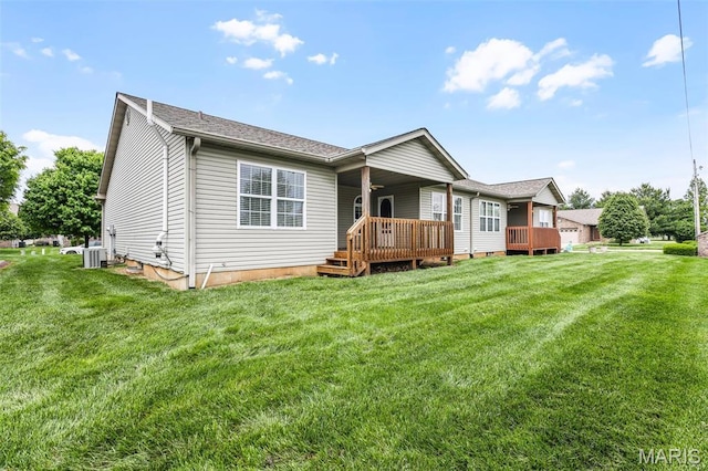 view of front of house featuring central air condition unit, a front lawn, and a wooden deck