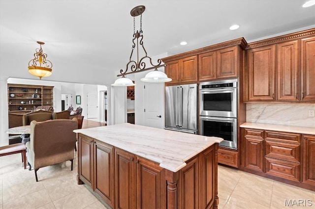 kitchen with stainless steel appliances, hanging light fixtures, a center island, light tile patterned flooring, and recessed lighting