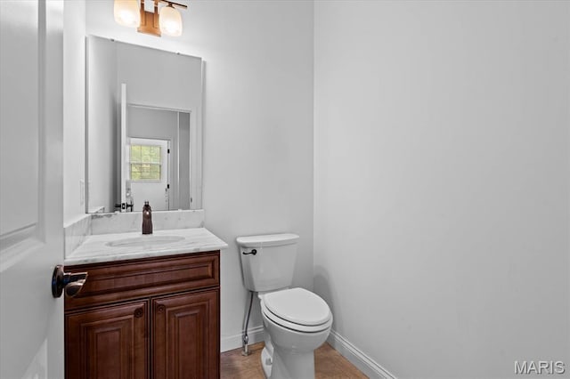 half bathroom featuring toilet and vanity