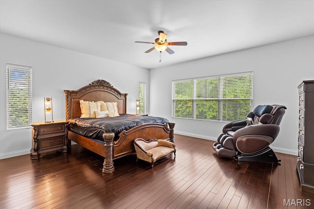 bedroom featuring baseboards, wood finished floors, and a ceiling fan