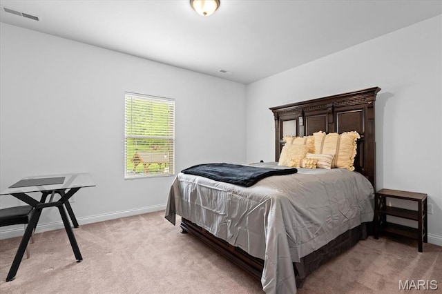 bedroom with light carpet and baseboards