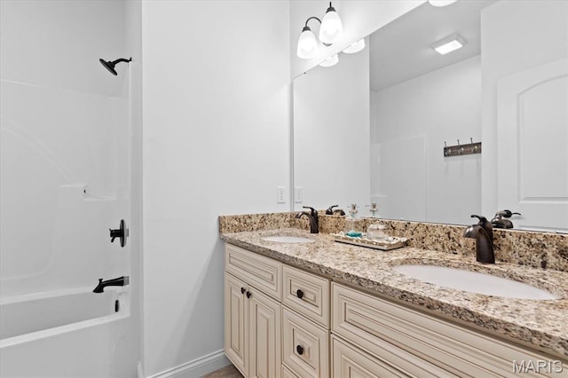full bathroom featuring tub / shower combination, double vanity, and baseboards