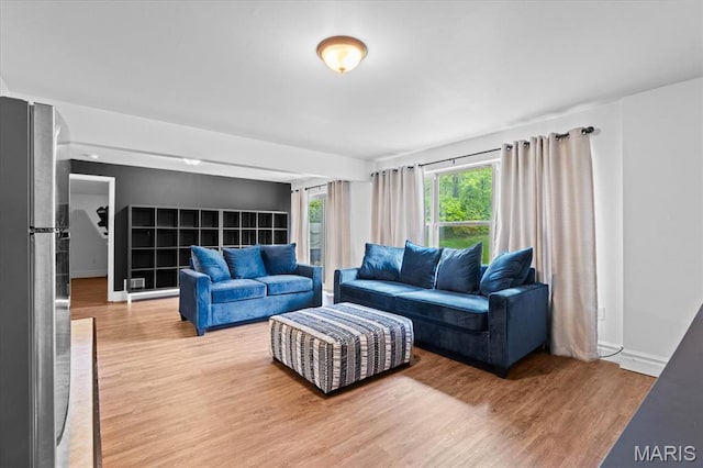 living area with wood finished floors and baseboards