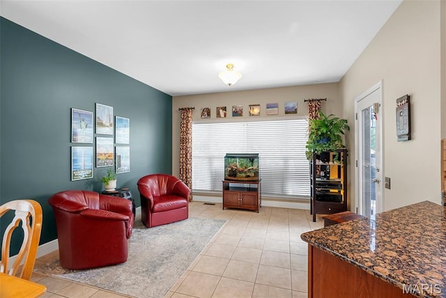 living room with healthy amount of natural light, light tile patterned floors, and baseboards