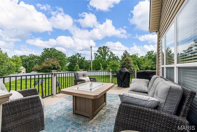 wooden terrace with an outdoor living space, view of wooded area, and a yard