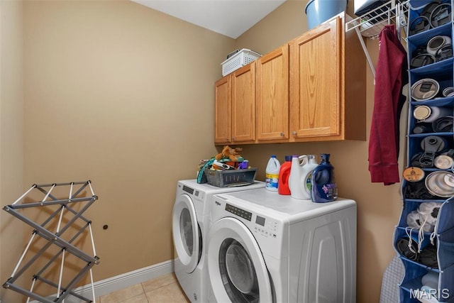 laundry area with washer and dryer, cabinet space, light tile patterned floors, and baseboards