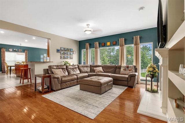 living area with hardwood / wood-style floors and recessed lighting