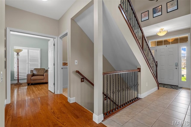 foyer with baseboards and wood finished floors