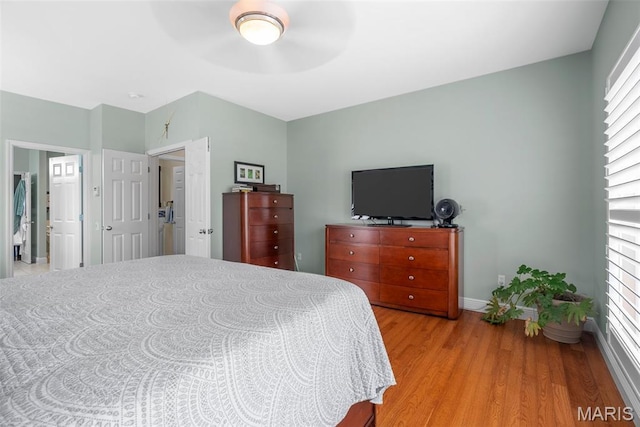 bedroom with light wood-style floors, baseboards, and ceiling fan