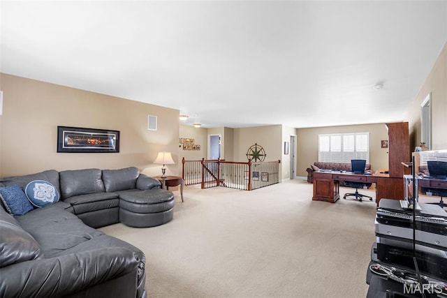 living room featuring a desk and light carpet
