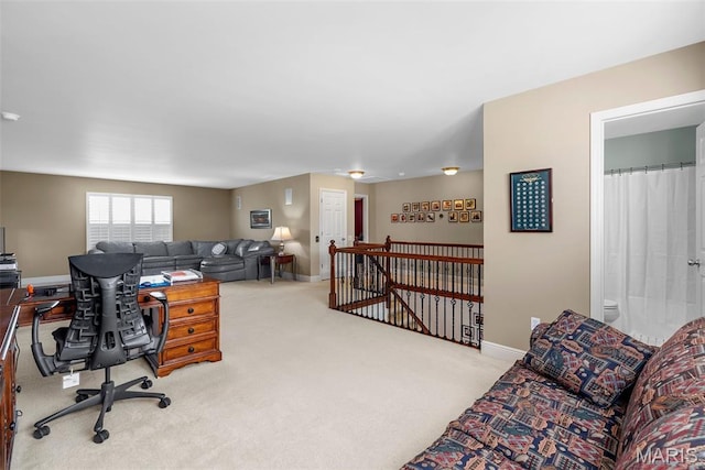 carpeted home office featuring baseboards