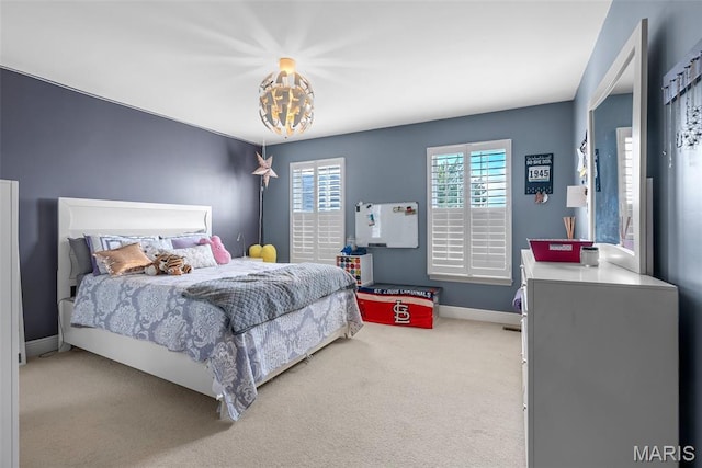bedroom featuring carpet, baseboards, and a chandelier