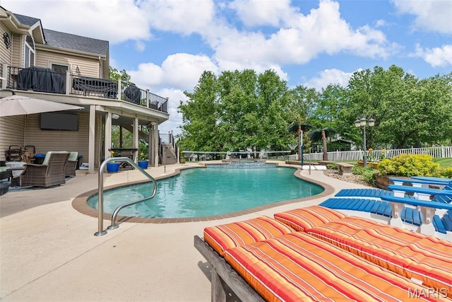 view of pool with a patio area and a pool with connected hot tub