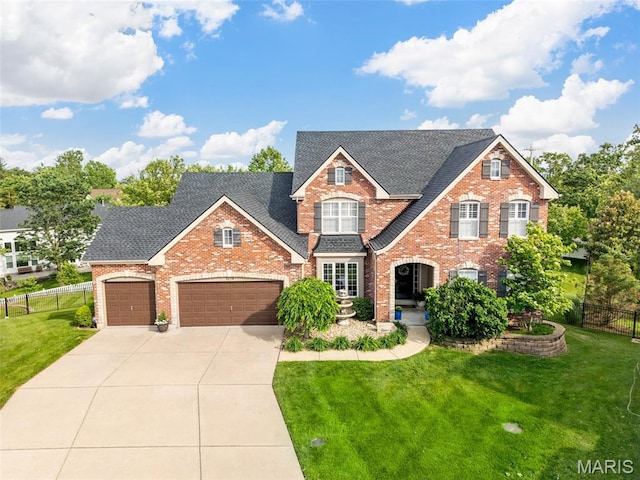 traditional-style home featuring brick siding, concrete driveway, an attached garage, and roof with shingles