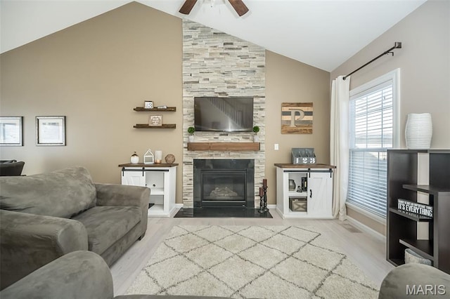 1119 Maywood Dr, Eureka, MO 63025 - living area with wood finished floors, a ceiling fan, a fireplace, and high vaulted ceiling