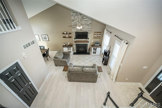 1119 Maywood Dr, Eureka, MO 63025 - living room with high vaulted ceiling, a fireplace, and light wood-style flooring