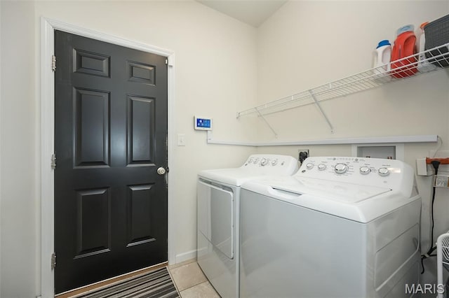 1119 Maywood Dr, Eureka, MO 63025 - laundry room with washing machine and clothes dryer and light tile patterned floors