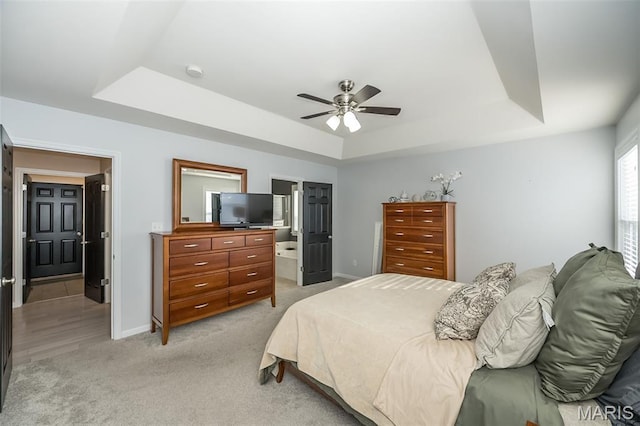 1119 Maywood Dr, Eureka, MO 63025 - bedroom featuring a tray ceiling, light colored carpet, a ceiling fan, and ensuite bathroom