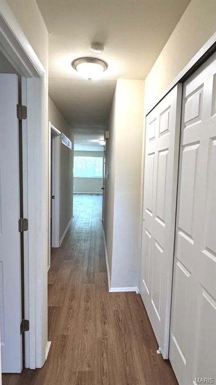 4028 Esseldale Dr, Saint Ann, MO 63074 - hall featuring dark wood-type flooring and baseboards