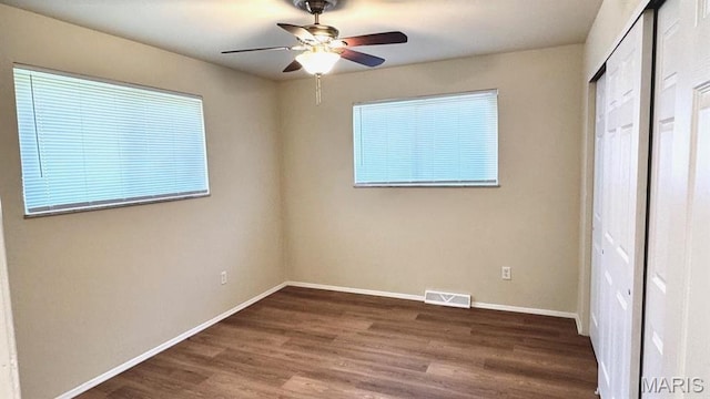 4028 Esseldale Dr, Saint Ann, MO 63074 - unfurnished bedroom featuring wood finished floors, baseboards, a ceiling fan, and a closet