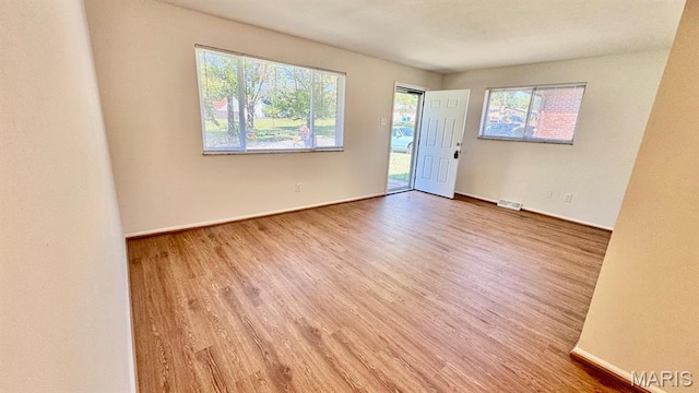 4028 Esseldale Dr, Saint Ann, MO 63074 - spare room featuring wood finished floors and baseboards