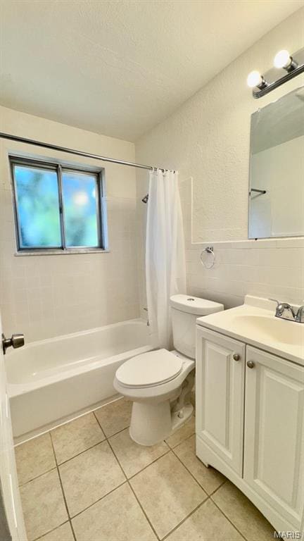 4028 Esseldale Dr, Saint Ann, MO 63074 - full bath with shower / bath combination with curtain, toilet, tile walls, tile patterned flooring, and vanity