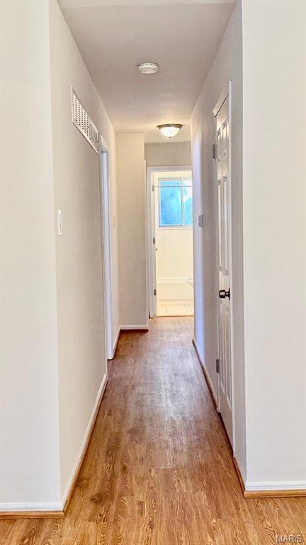 4028 Esseldale Dr, Saint Ann, MO 63074 - hallway with light wood-type flooring and baseboards