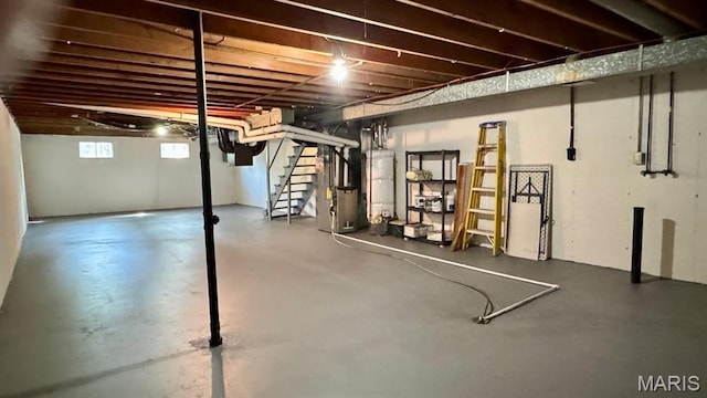 4028 Esseldale Dr, Saint Ann, MO 63074 - below grade area featuring stairs, water heater, and heating unit