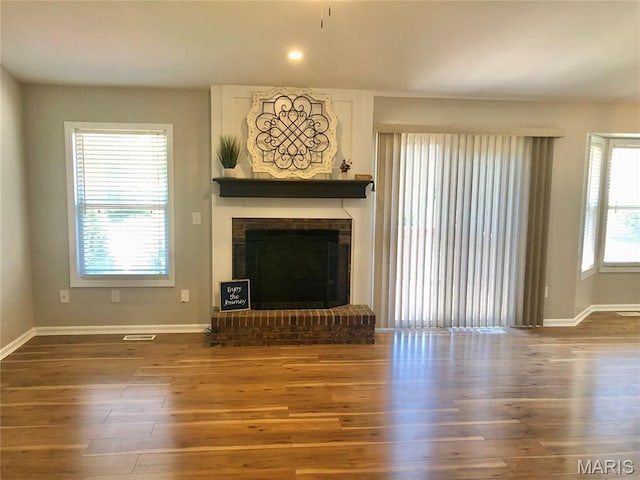 1215 Brookstone Ln, Lake St Louis, MO 63367 - unfurnished living room with baseboards, wood finished floors, a fireplace, and recessed lighting