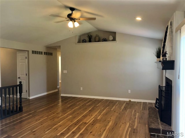 1215 Brookstone Ln, Lake St Louis, MO 63367 - unfurnished living room with ceiling fan, dark wood-style flooring, vaulted ceiling, a brick fireplace, and baseboards