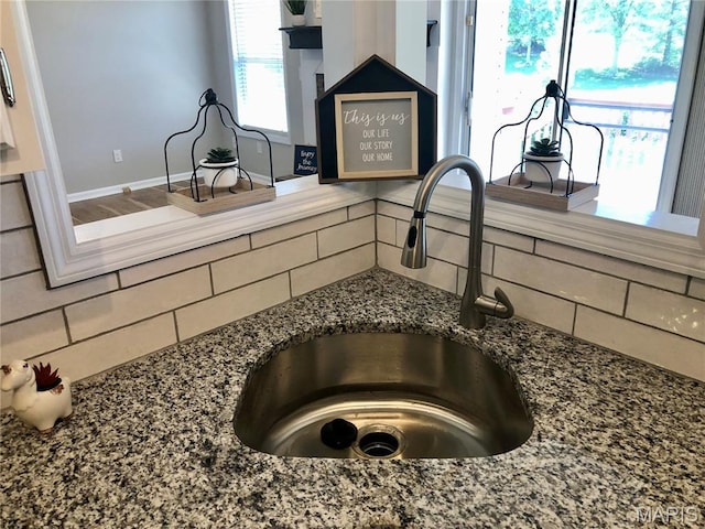 1215 Brookstone Ln, Lake St Louis, MO 63367 - kitchen view of a sink, tasteful backsplash, and dark stone counters