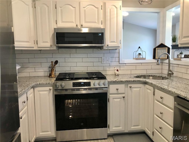 1215 Brookstone Ln, Lake St Louis, MO 63367 - kitchen with stainless steel appliances, a sink, and white cabinetry