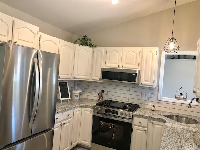 1215 Brookstone Ln, Lake St Louis, MO 63367 - kitchen featuring appliances with stainless steel finishes, a sink, vaulted ceiling, backsplash, and light stone countertops