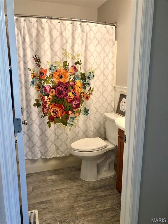 1215 Brookstone Ln, Lake St Louis, MO 63367 - bathroom with toilet, vanity, and a shower with shower curtain