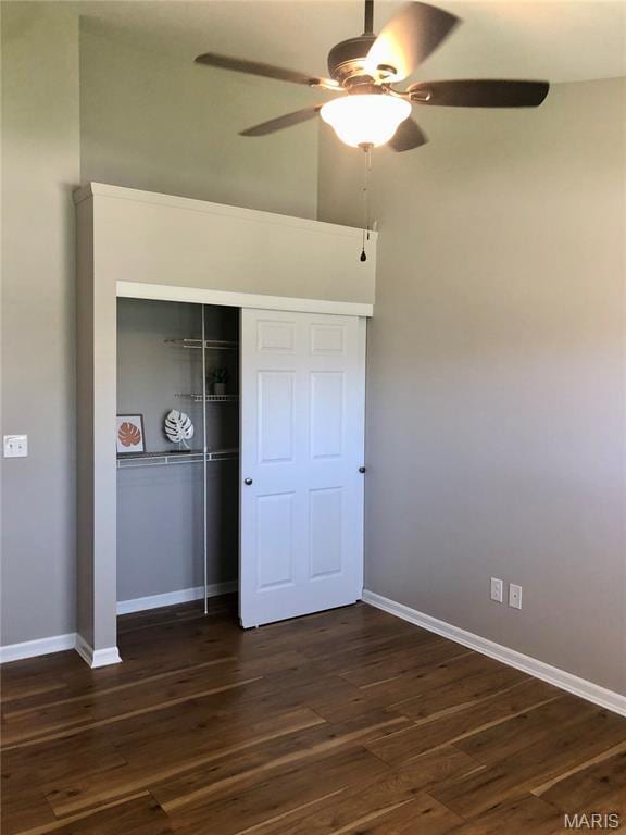 1215 Brookstone Ln, Lake St Louis, MO 63367 - unfurnished bedroom featuring baseboards, dark wood-style flooring, a closet, and ceiling fan