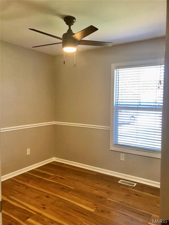 1215 Brookstone Ln, Lake St Louis, MO 63367 - empty room with ceiling fan, baseboards, and wood finished floors