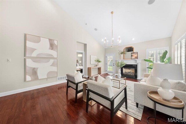 427 Newkirk Cir, Saint Charles, MO 63303 - living room with high vaulted ceiling, healthy amount of natural light, dark wood finished floors, a chandelier, and baseboards