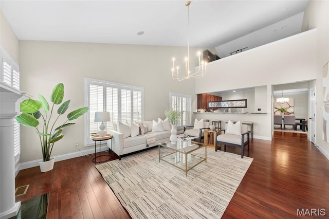 427 Newkirk Cir, Saint Charles, MO 63303 - living room with a chandelier, high vaulted ceiling, wood finished floors, and baseboards