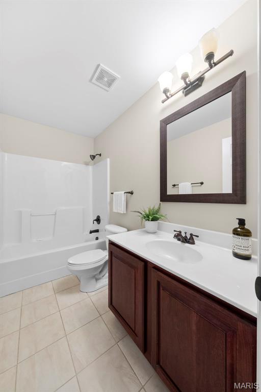 427 Newkirk Cir, Saint Charles, MO 63303 - bathroom featuring vanity, shower / washtub combination, toilet, and tile patterned floors