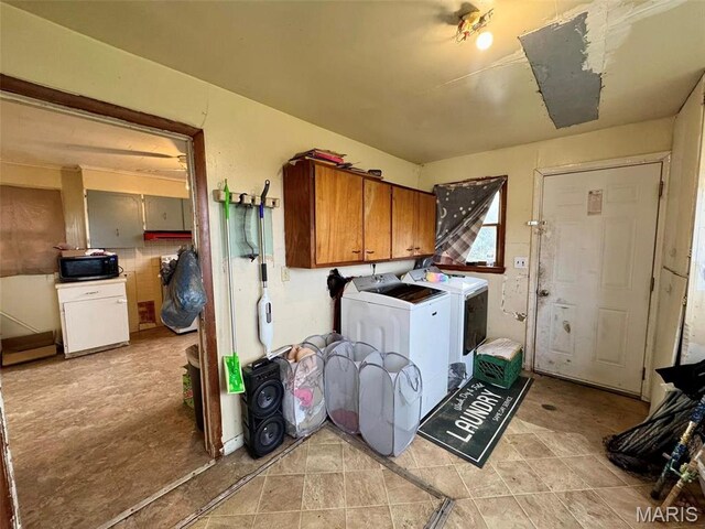 washroom with separate washer and dryer and cabinet space