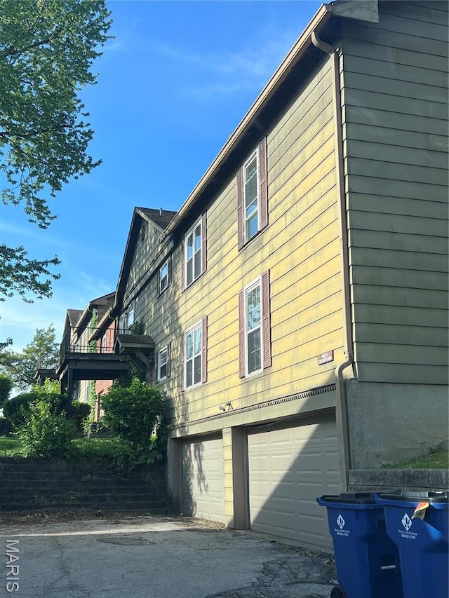 view of side of property featuring an attached garage