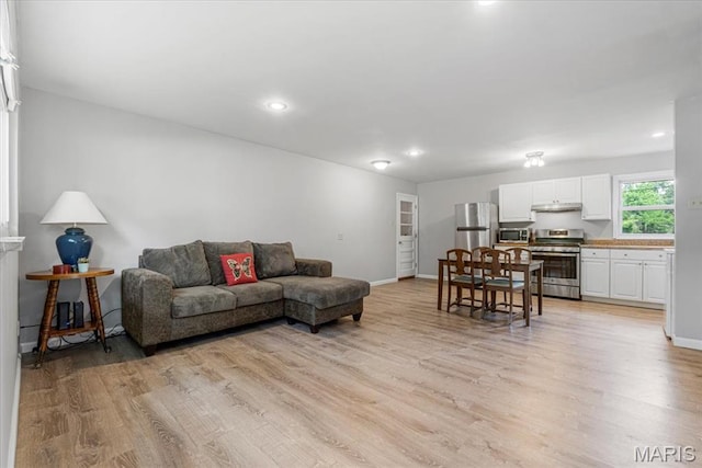 284 Ramsey Ln, Ballwin, MO 63021 - living area with light wood finished floors, baseboards, and recessed lighting