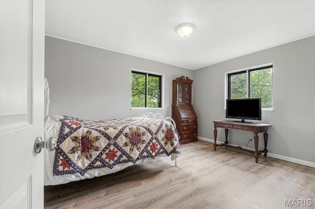 284 Ramsey Ln, Ballwin, MO 63021 - bedroom with wood finished floors, multiple windows, and baseboards