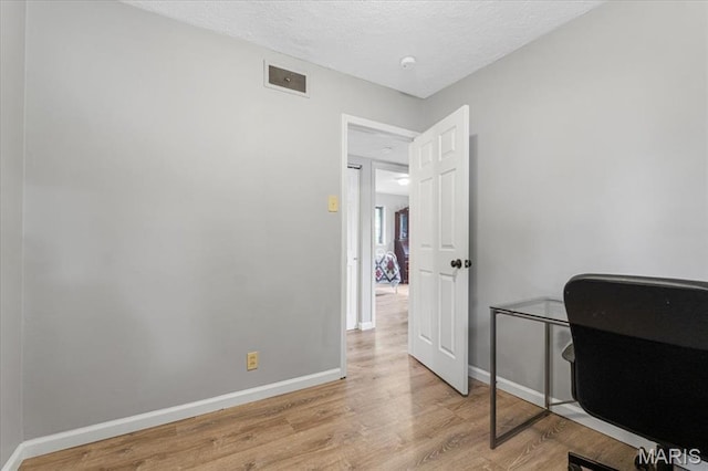 284 Ramsey Ln, Ballwin, MO 63021 - home office featuring light wood finished floors, baseboards, and a textured ceiling